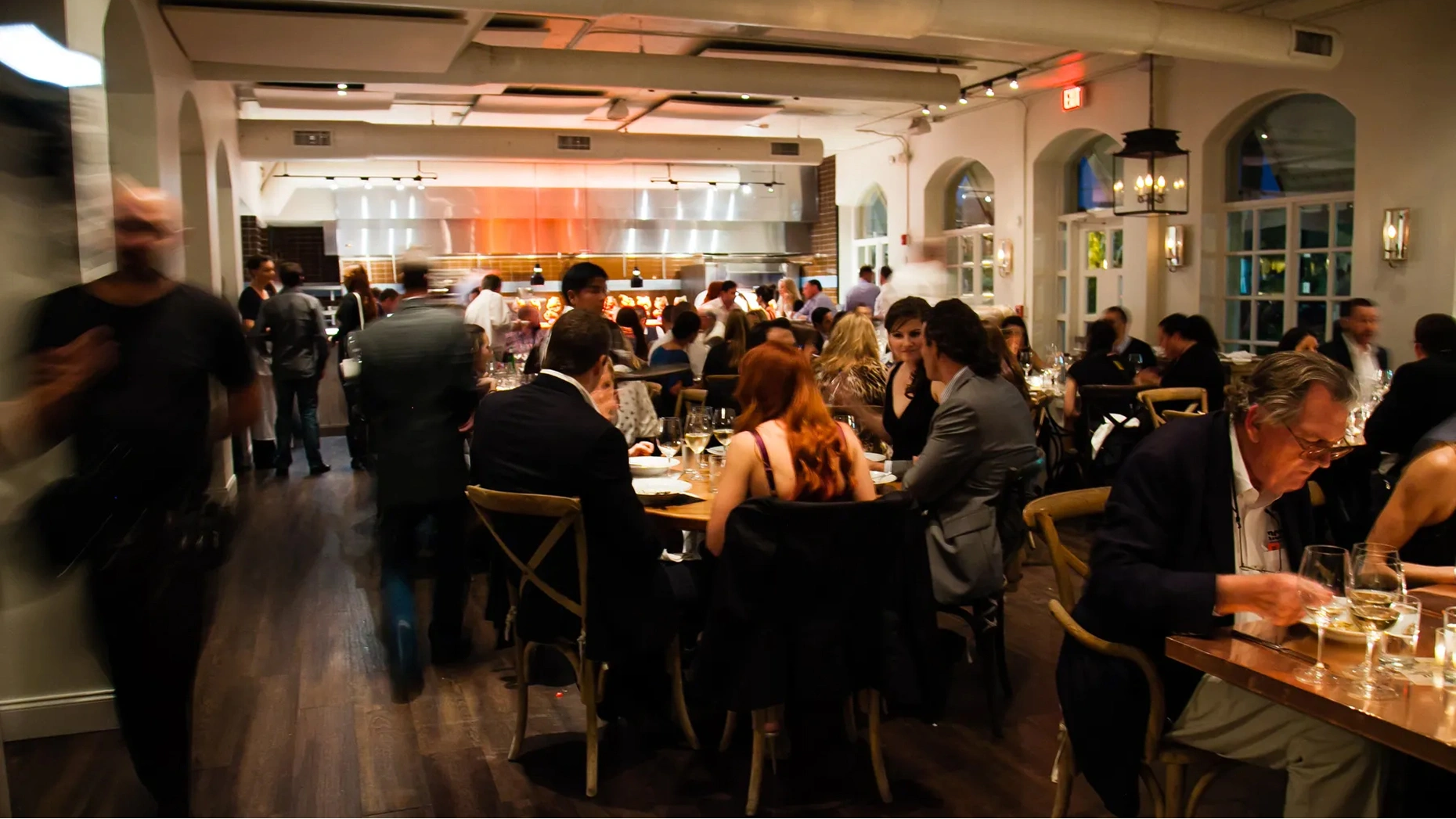 The vibrant, tile-roofed exterior and lively bar scene at Buccan, a hip global cafe in Palm Beach.
