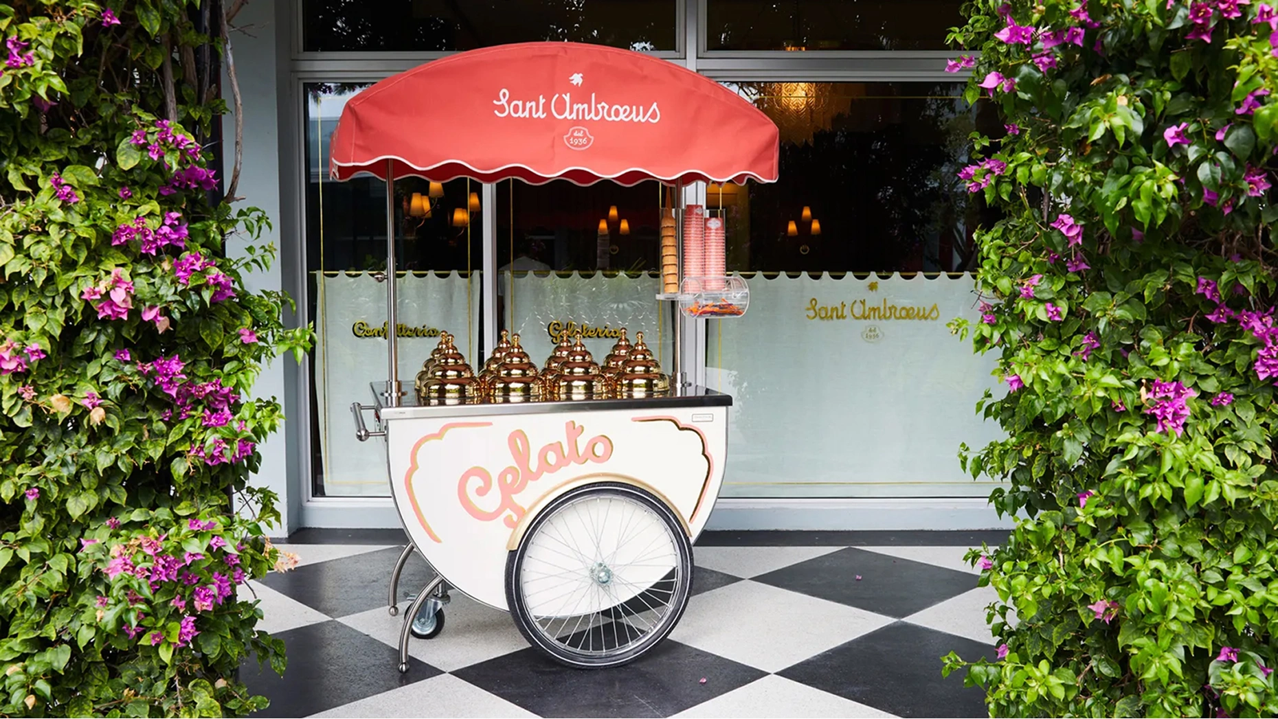 Elegant outdoor patio dining at Sant Ambroeus Palm Beach with white tablecloths and Italian decor.