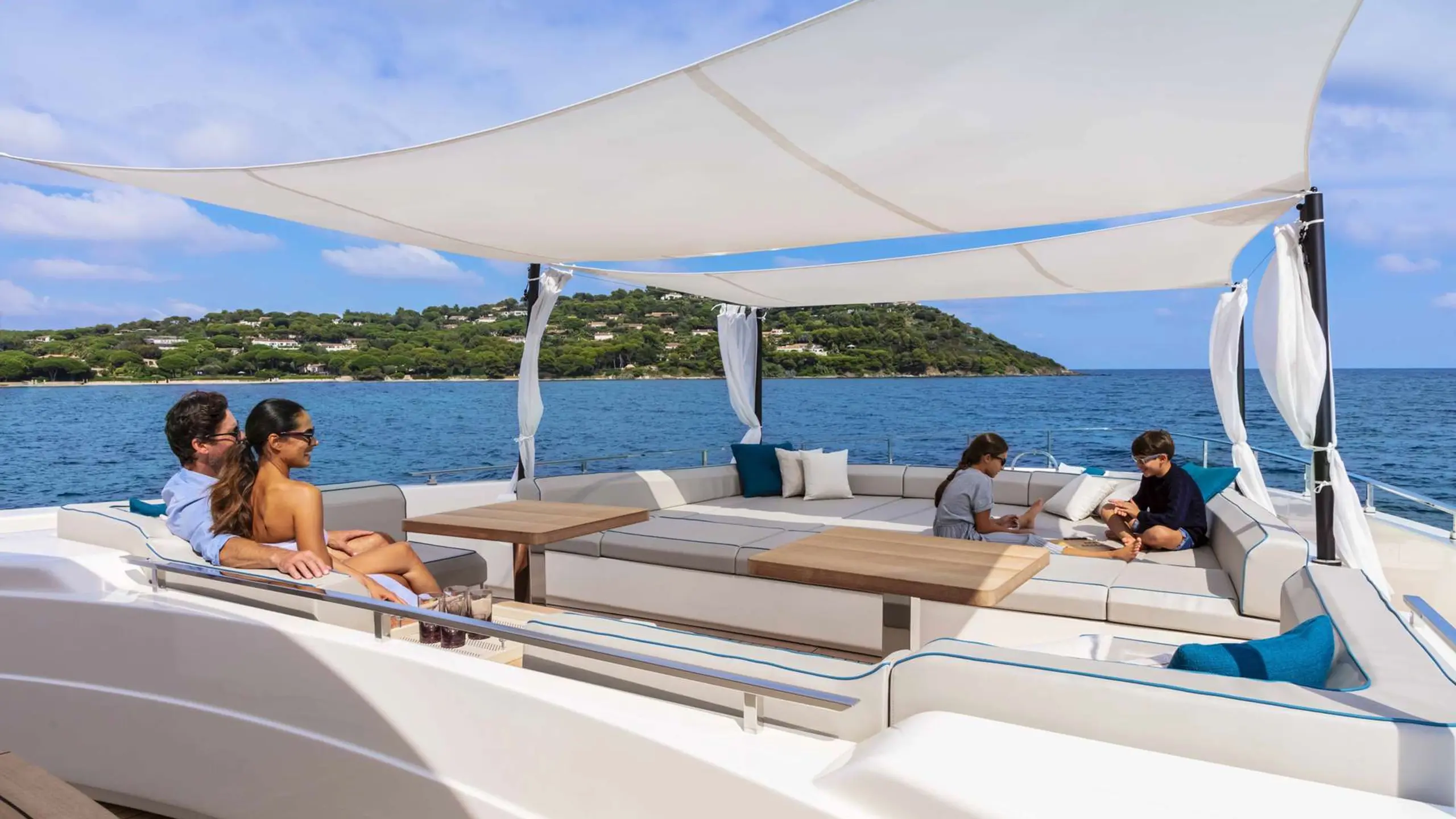 Flybridge motoryacht with guests on upper deck entertaining