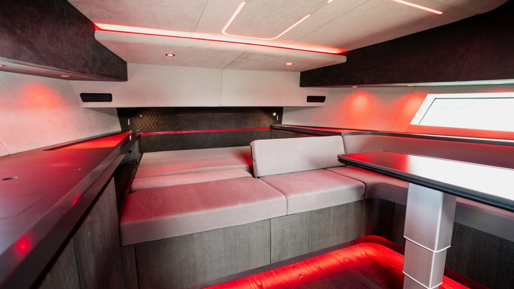 Maori M54 XL Mana luxury cabin interior with custom bed, galley, and full head with shower