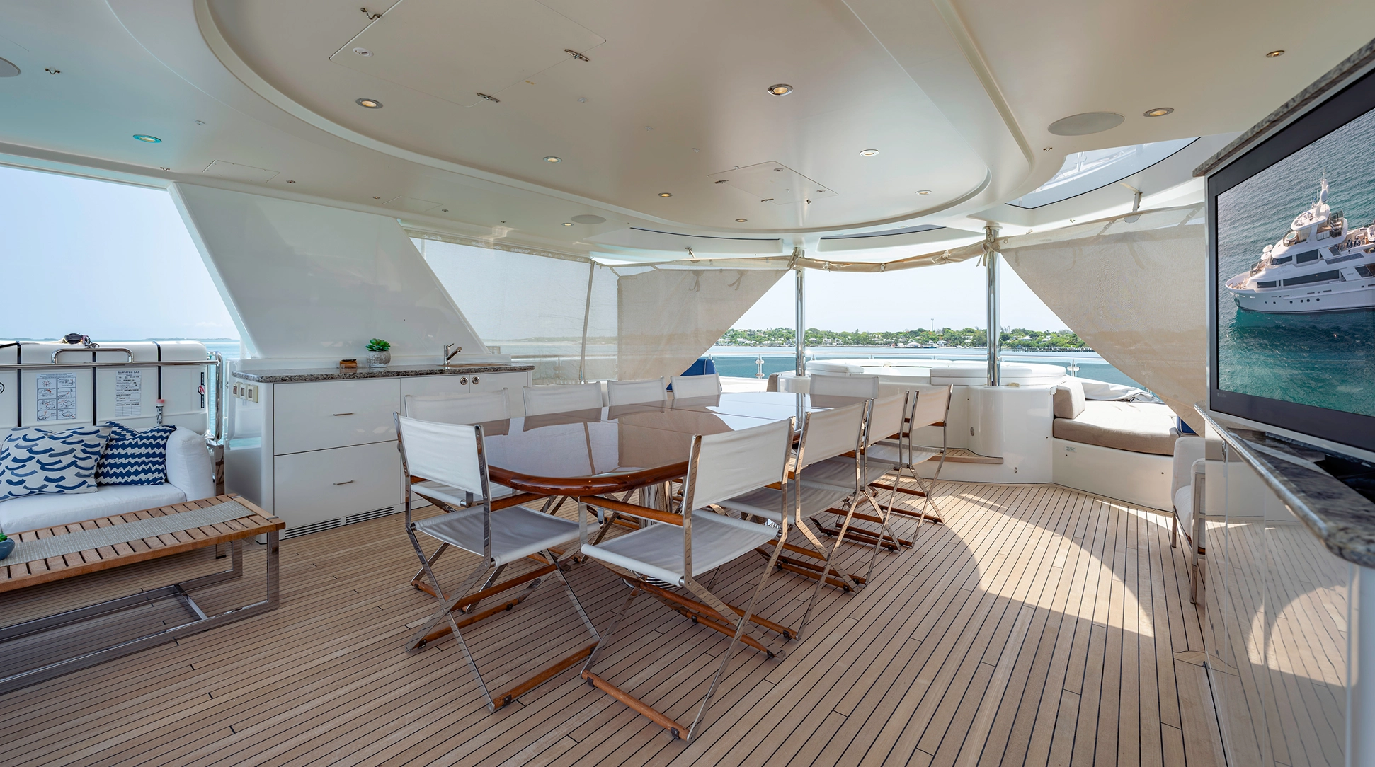 Westport 40M aft deck entertaining space — covered dining and wet bar, FAR NIENTE sold