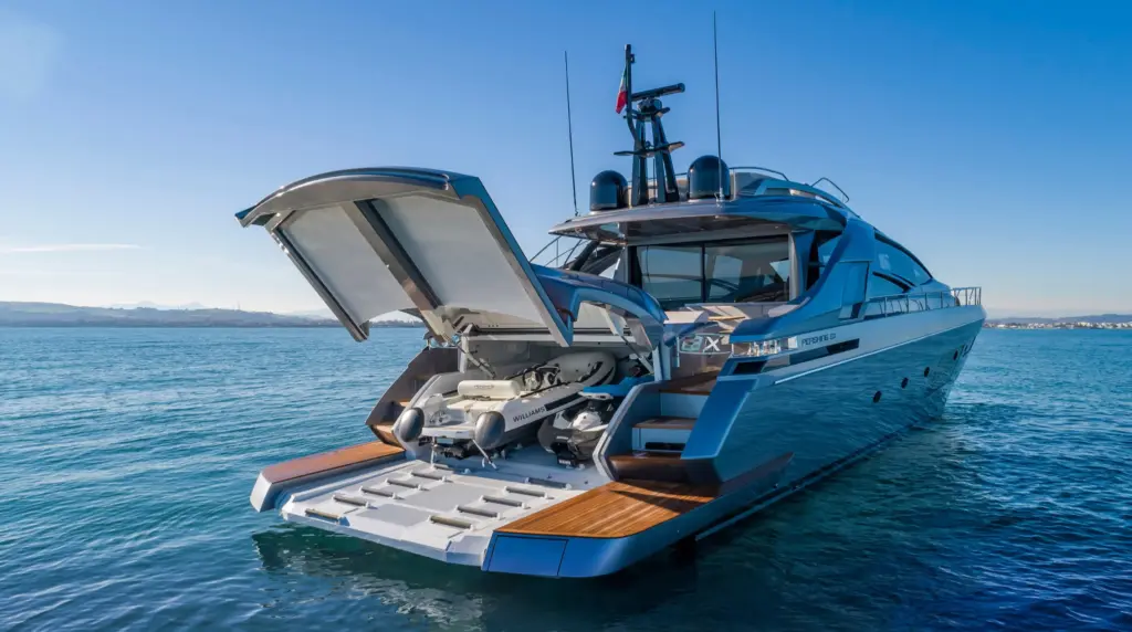 Pershing 8X stern with garage open, revealing Williams tender and deployed teak beach platform